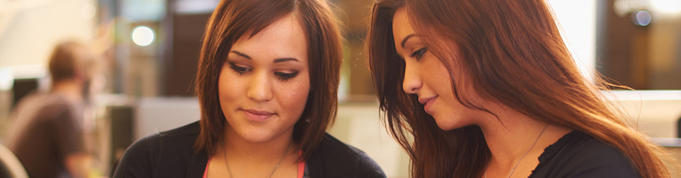 Two students looking down below the camera