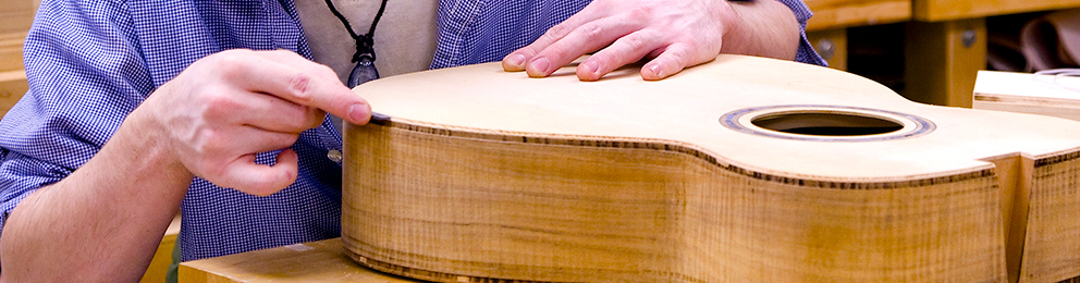 Student working on an acoustic guitar