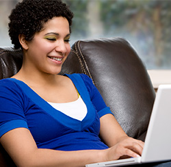 Student on Sofa with Laptop