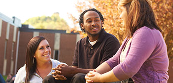 Three students talking outside