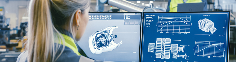 Woman looking at CAD images on dual monitors