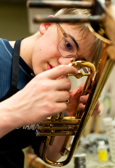 Student working on a brass insturment