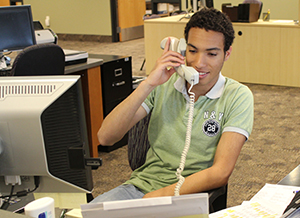 Work study student talking on a telephone