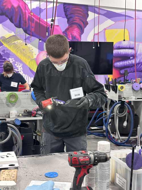 Michael Stangler, wearing a mask, demonstrates his skills during a portion of the 3M Skills competition