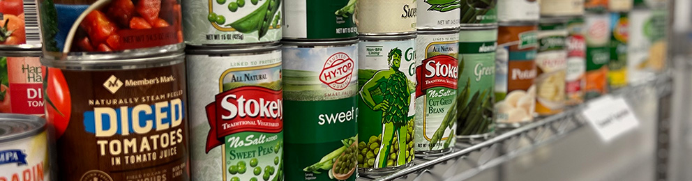 rows of canned goods stacked on a shelf
