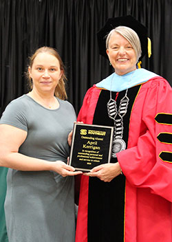 April poses alongside Marsha Danielson