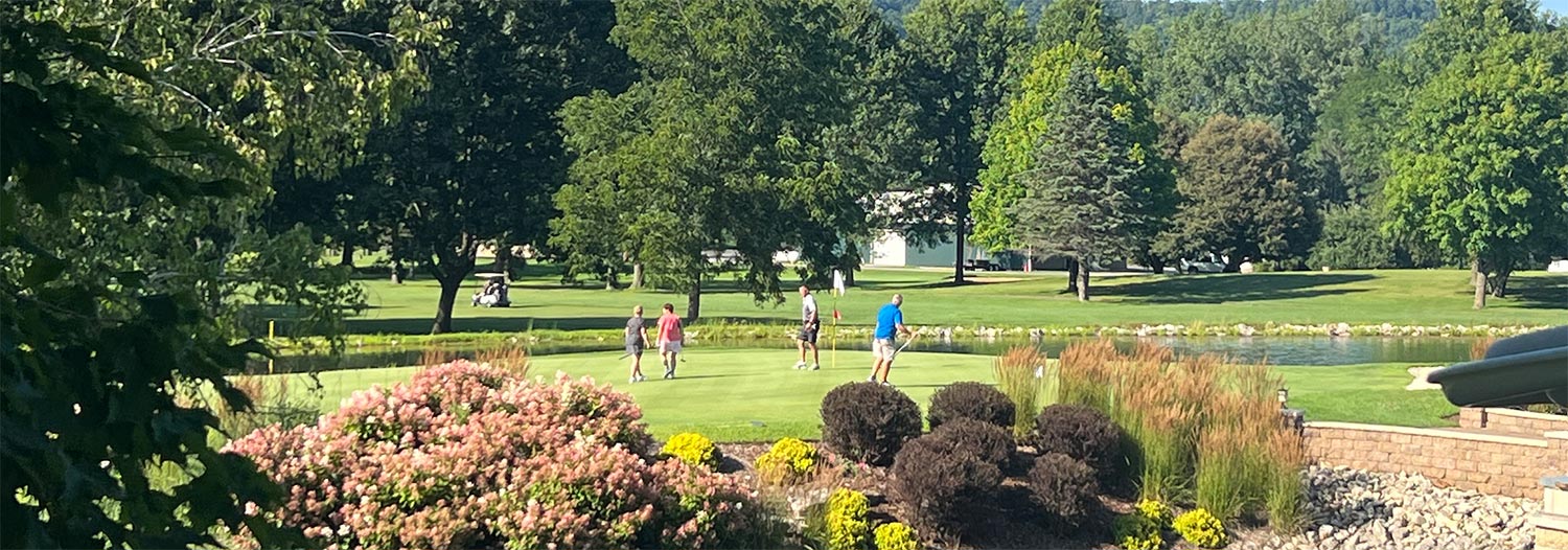 Wide shot of a golfers on a golf course green
