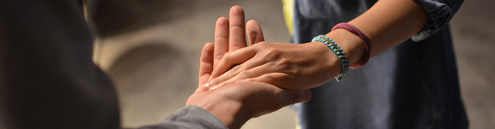 Close up of someone putting their hand in another's